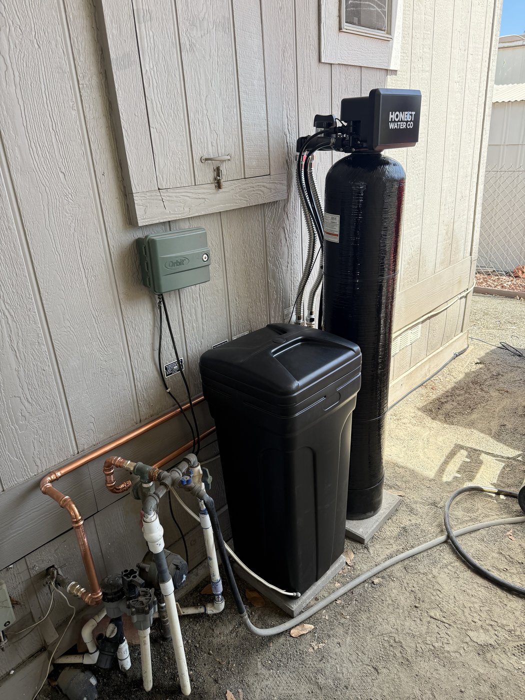 Sol Connection side-yard water softener installation with copper manifold in Southern California
